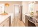 Bright kitchen showcasing quartz countertops, white cabinets, stainless appliances and attractive wicker light fixture at 1211 Lem Rd, Cordesville, SC 29434