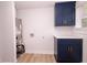 Functional laundry room featuring navy cabinets, quartz counters, and washer/dryer hookups at 1211 Lem Rd, Cordesville, SC 29434