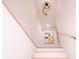 White staircase with wooden handrail and decorative wall art at 1211 Lem Rd, Cordesville, SC 29434