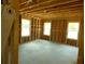 Interior view of a framed room with three windows, showcasing the construction progress at 1219 Pineville Cir, Pineville, SC 29468