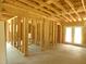 Interior view of framing and exposed beams, featuring a doorway, windows, and a door to the outside at 1219 Pineville Cir, Pineville, SC 29468