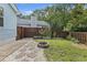Backyard featuring stone path, fire pit, wooden fence, and raised garden beds for outdoor enjoyment at 1245 Lakefront Drive Dr, Charleston, SC 29412