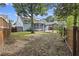 A full view of the backyard from the fence line, highlighting the mature trees and pergola covered patio at 1245 Lakefront Drive Dr, Charleston, SC 29412