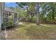 The backyard features a mature tree, patio, and a wooden fence providing privacy and a peaceful ambiance at 1245 Lakefront Drive Dr, Charleston, SC 29412