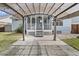 A backyard patio featuring a covered pergola with entrance to the screened-in back porch at 1245 Lakefront Drive Dr, Charleston, SC 29412