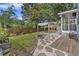 Beautiful backyard with patio, stone pathway, landscaped garden, fire pit, and mature trees at 1245 Lakefront Drive Dr, Charleston, SC 29412