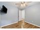 Bedroom features wood floors, a ceiling fan, a TV, and light blue walls at 1245 Lakefront Drive Dr, Charleston, SC 29412