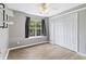 A bedroom with neutral walls, hardwood floors, large window, and closet at 1245 Lakefront Drive Dr, Charleston, SC 29412