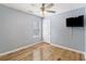 Comfortable bedroom with a ceiling fan, wood floors, and a bright window at 1245 Lakefront Drive Dr, Charleston, SC 29412
