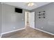 Neutral-toned bedroom featuring shelving, hardwood floors, and a mounted TV at 1245 Lakefront Drive Dr, Charleston, SC 29412
