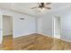 A spacious bedroom with a ceiling fan, hardwood floors, and open doorways at 1245 Lakefront Drive Dr, Charleston, SC 29412