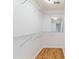 Walk-in closet features white shelving with wood floors and a mirror at 1245 Lakefront Drive Dr, Charleston, SC 29412
