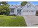 Beautiful light blue home with a well-manicured lawn and an attached two-car garage at 1245 Lakefront Drive Dr, Charleston, SC 29412