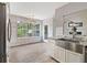 Bright kitchen featuring a stainless steel sink, white cabinets, a farmhouse sink, and a view to the outside at 1245 Lakefront Drive Dr, Charleston, SC 29412