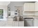 Bright kitchen featuring a stainless steel sink, white cabinets, a farmhouse sink, and a view to the living room at 1245 Lakefront Drive Dr, Charleston, SC 29412