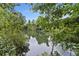 Scenic lake view framed by trees, reflecting the blue sky and natural surroundings in the calm water at 1245 Lakefront Drive Dr, Charleston, SC 29412