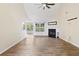 Bright living room features a fireplace, ceiling fan, wood-look tile floors, and ample natural light at 1245 Lakefront Drive Dr, Charleston, SC 29412