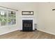 Cozy room featuring a fireplace, large window providing natural light, and light wood-look flooring at 1245 Lakefront Drive Dr, Charleston, SC 29412