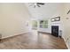 Bright living room with fireplace, ceiling fan, wood-look tile floors, and ample natural light at 1245 Lakefront Drive Dr, Charleston, SC 29412