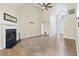 Spacious living room with fireplace, vaulted ceiling, ceiling fan, and light wood-look flooring at 1245 Lakefront Drive Dr, Charleston, SC 29412