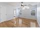 Light and airy main bedroom with hardwood floors, a ceiling fan, and a door to the bathroom at 1245 Lakefront Drive Dr, Charleston, SC 29412