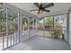 Relaxing screened porch featuring a ceiling fan, wood floors, and views of the backyard at 1245 Lakefront Drive Dr, Charleston, SC 29412