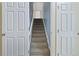 Carpeted stairway with white trim, doors, and blue walls is well-lit at 1245 Lakefront Drive Dr, Charleston, SC 29412