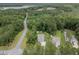Aerial shot of suburban homes surrounded by lush trees, with a street bisecting the landscape at 125 Beam St, Huger, SC 29450