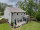 Aerial view of a backyard with a patio, screened-in porch, and a grill, surrounded by a lush green lawn at 125 Beam St, Huger, SC 29450