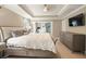 Comfortable main bedroom suite with a large bed, decorative tray ceiling, and sitting room at 125 Beam St, Huger, SC 29450