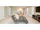 Comfortable bonus room offers a large television and a relaxing gray chaise lounge at 125 Beam St, Huger, SC 29450