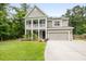 Two-story home with a welcoming porch, neutral siding, and a manicured front lawn at 125 Beam St, Huger, SC 29450