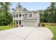 Beautifully landscaped home with two-story facade, stacked porches, and a spacious driveway at 125 Beam St, Huger, SC 29450