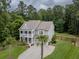 Beautiful home featuring lush landscaping, stacked porches and a lovely front yard at 125 Beam St, Huger, SC 29450