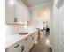 Bright hallway featuring white cabinets with granite countertops; leads to dining room at 125 Beam St, Huger, SC 29450