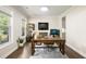 Comfortable home office featuring a large desk, shelving unit, and large window at 125 Beam St, Huger, SC 29450