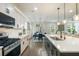 Open kitchen featuring stainless steel appliances, white cabinets, and a large island at 125 Beam St, Huger, SC 29450