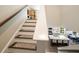 Bright staircase with hardwood treads leading to a view of the kitchen and dining area at 125 Beam St, Huger, SC 29450