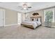 Spacious bedroom with a decorative headboard, ceiling fan, and ample natural light at 1304 Lieben Rd, Mount Pleasant, SC 29466