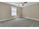 Neutral bedroom with cozy carpet, bright window, ceiling fan, and light walls for comfortable living at 1304 Lieben Rd, Mount Pleasant, SC 29466