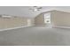 Large bonus room with cozy carpet, bright window, ceiling fan, and light walls for comfortable living at 1304 Lieben Rd, Mount Pleasant, SC 29466