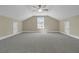 Large bonus room with cozy carpet, bright window, ceiling fan, and light walls for comfortable living at 1304 Lieben Rd, Mount Pleasant, SC 29466