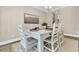 Bright dining room with decoratively set white table and chairs, adjacent to the kitchen at 1304 Lieben Rd, Mount Pleasant, SC 29466