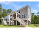 Stately home boasts an elevated porch, wood and white exterior, and manicured lawn, offering a luxurious curb appeal at 1304 Lieben Rd, Mount Pleasant, SC 29466
