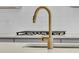 Close-up of kitchen sink with a gold faucet and white subway tile backsplash at 1304 Lieben Rd, Mount Pleasant, SC 29466