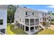 Gray home with a screened porch, white stairs, and lush greenery at 1304 Lieben Rd, Mount Pleasant, SC 29466
