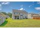 Exterior of the home viewed from the backyard with screened in porch and lush green lawn at 143 Airy Dr, Summerville, SC 29486