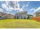 Large backyard featuring a lush lawn, privacy fencing, and the home's exterior, great for outdoor activities at 143 Airy Dr, Summerville, SC 29486
