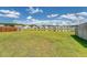 Grassy backyard with water feature and homes in the background at 143 Airy Dr, Summerville, SC 29486