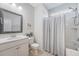 Neutral-toned bathroom featuring a shower-tub combination and a framed vanity mirror at 143 Airy Dr, Summerville, SC 29486